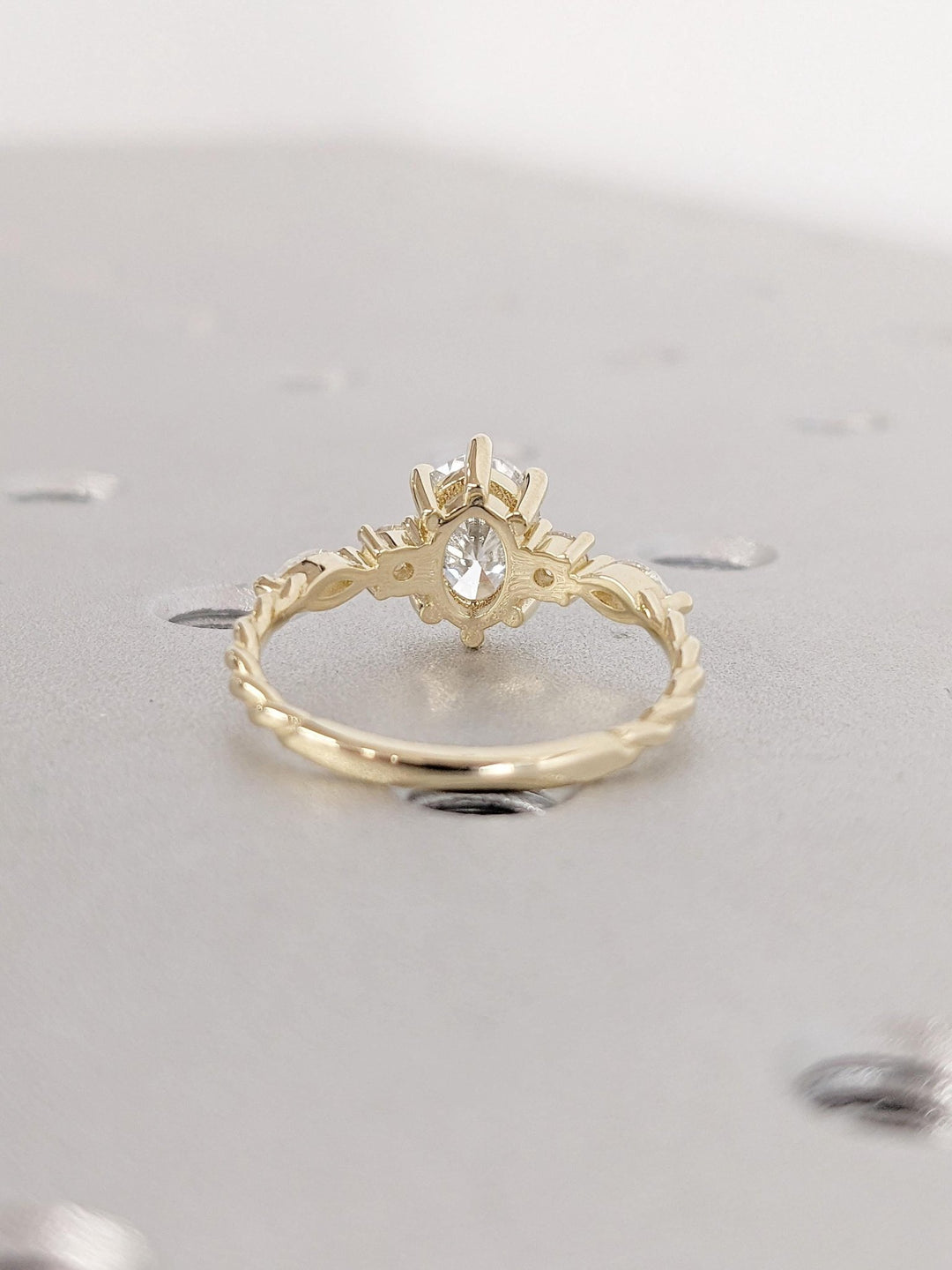 Oval cluster engagement ring close-up highlighting diamond sparkle