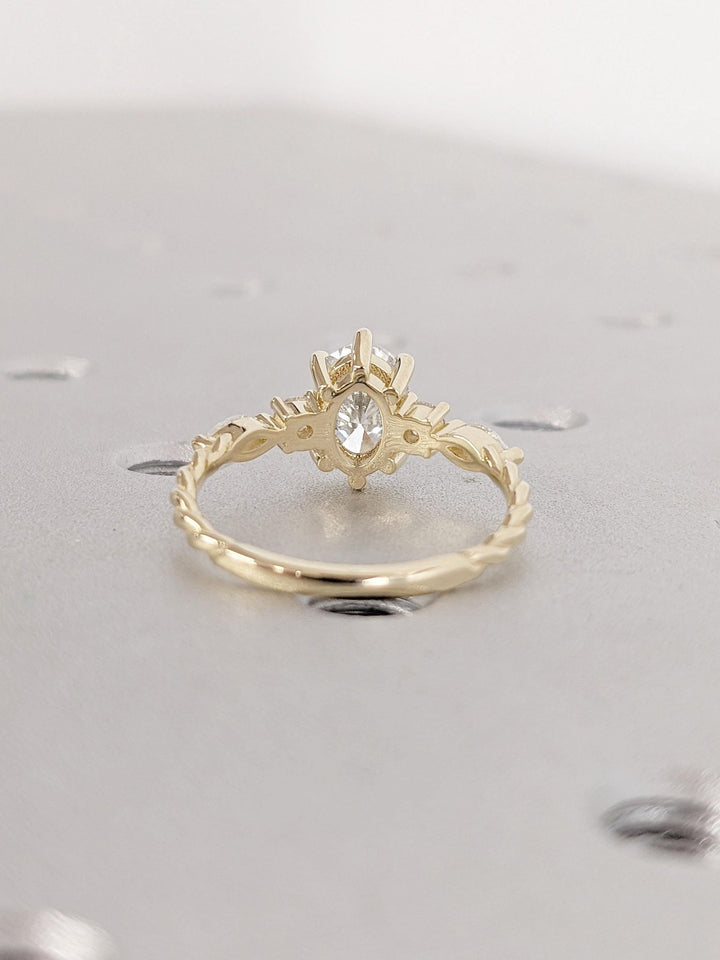 Oval cluster engagement ring close-up highlighting diamond sparkle