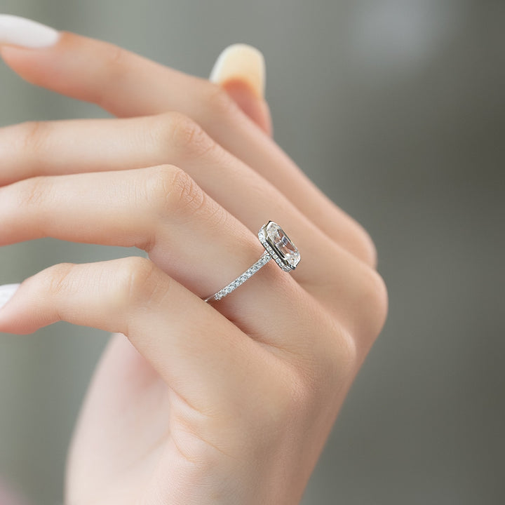 Certified emerald cut diamond featured in bezel engagement ring
