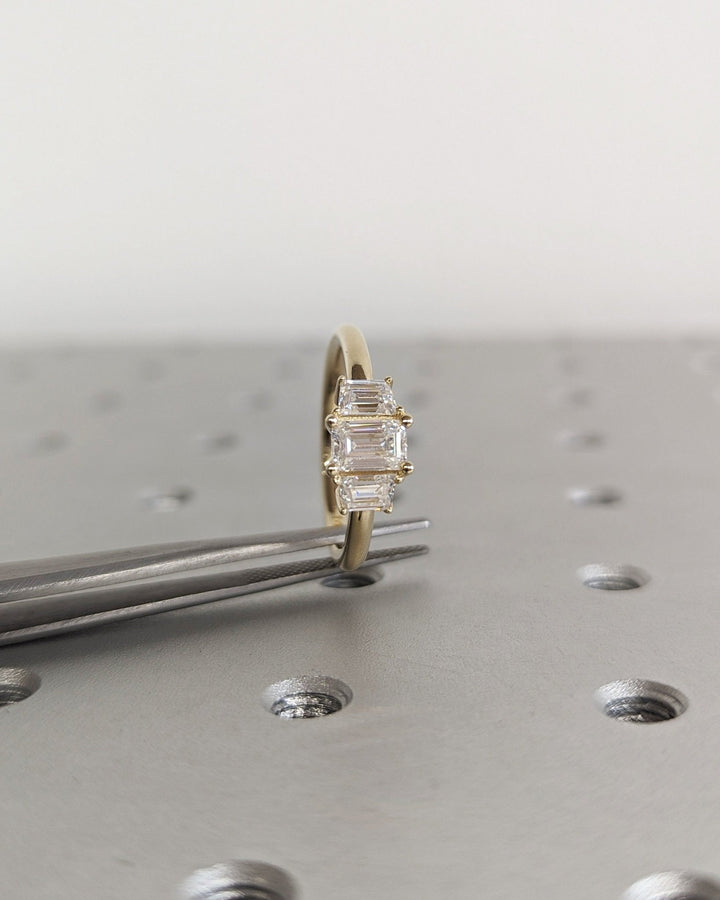 Profile view of emerald cut solitaire engagement ring band