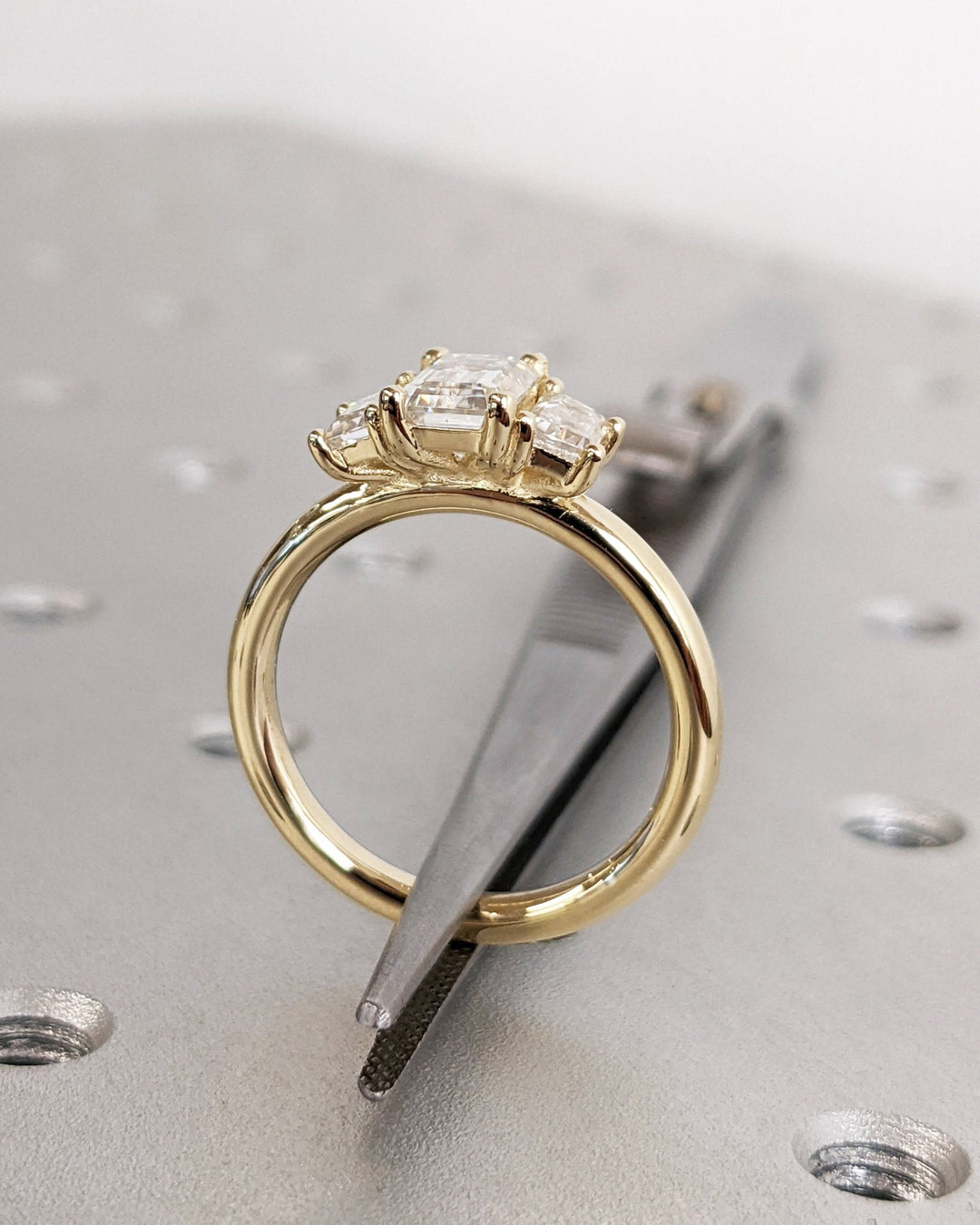 Emerald solitaire engagement ring with brilliant diamond sparkle