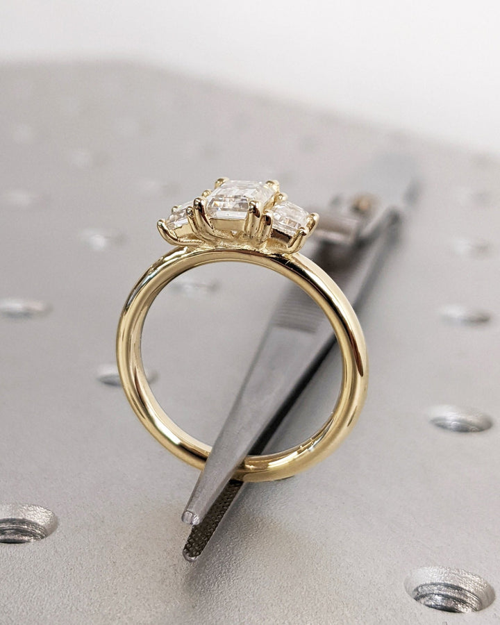 Emerald solitaire engagement ring with brilliant diamond sparkle