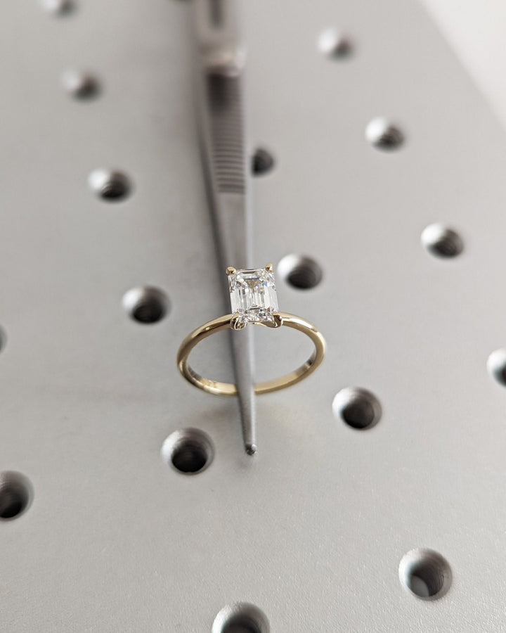 Emerald solitaire lab grown diamond ring fitted on finger