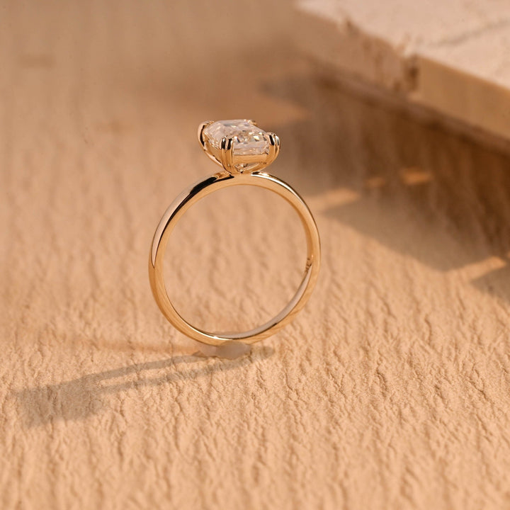 Detailed close-up of emerald solitaire diamond engagement ring
