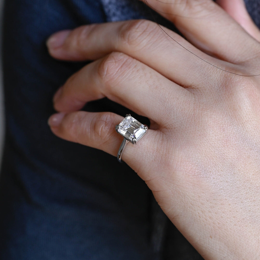Emerald solitaire engagement ring with brilliant diamond sparkle