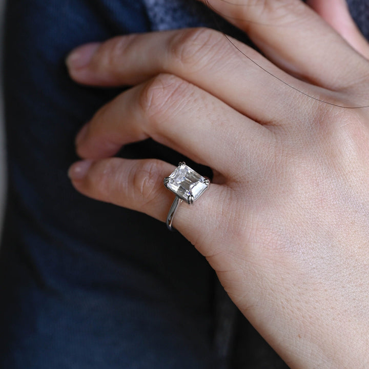 Emerald solitaire engagement ring with brilliant diamond sparkle