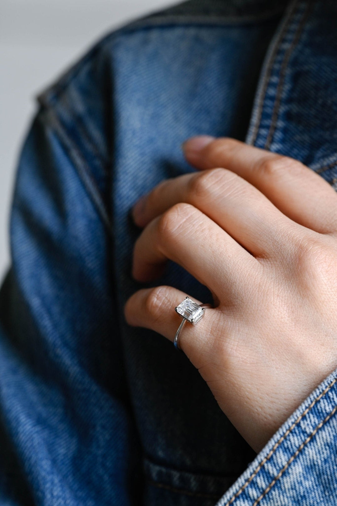 Unboxing view of emerald cut solitaire diamond engagement ring