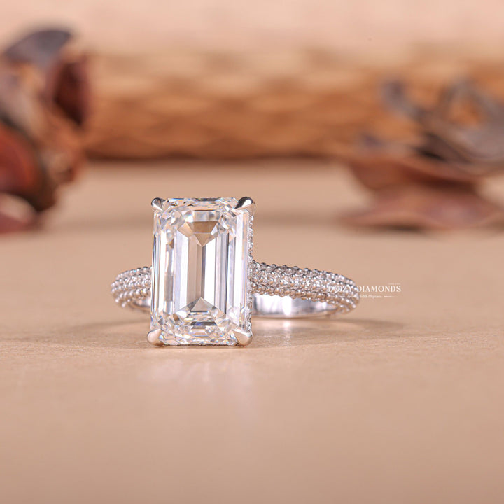 Emerald hidden halo engagement ring close-up highlighting diamond sparkle