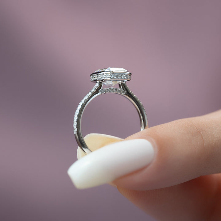 Emerald bezel ring set with an IGI graded diamond