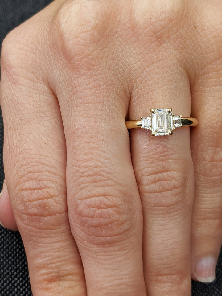 Detailed close-up of emerald solitaire diamond engagement ring