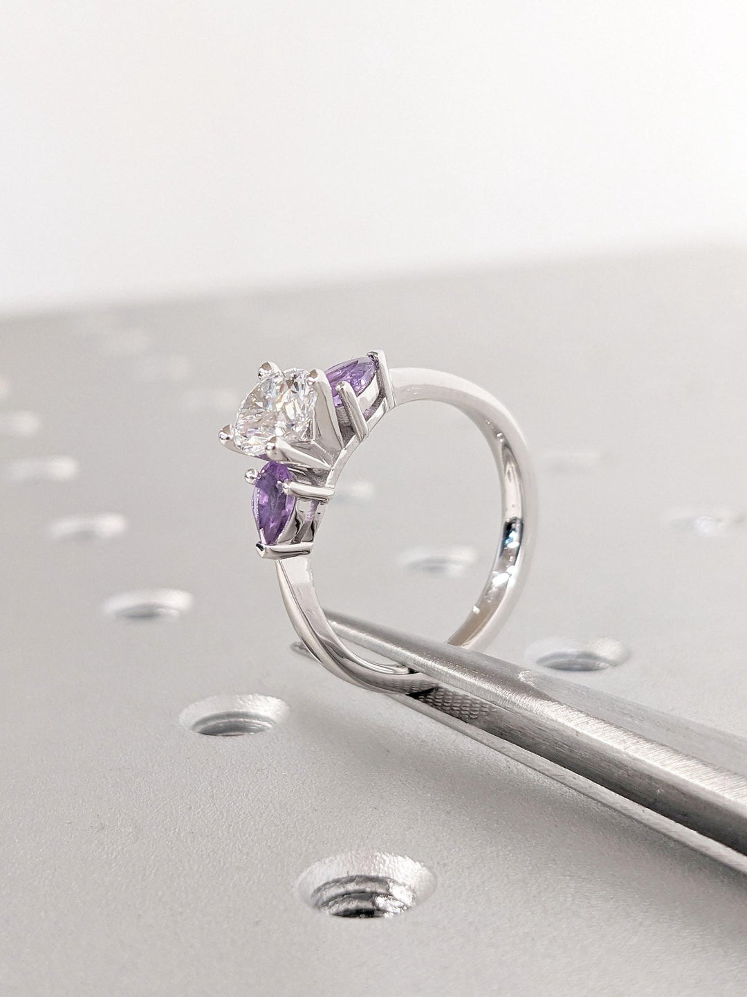 Round solitaire engagement ring photographed in natural light