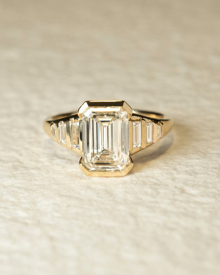 Emerald solitaire diamond engagement ring available in multiple metals