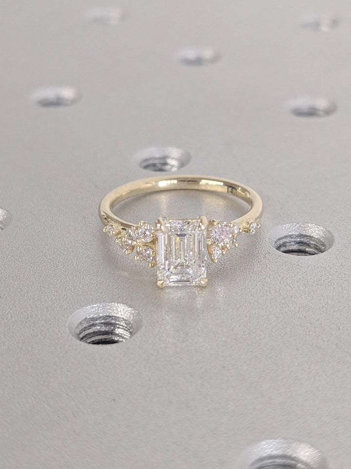 Emerald cluster engagement ring photographed in natural light