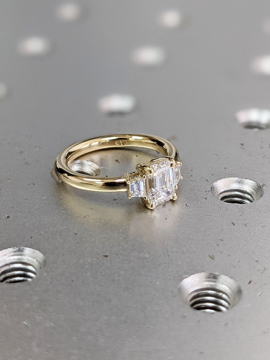 Macro shot of emerald cut diamond facets in solitaire ring setting