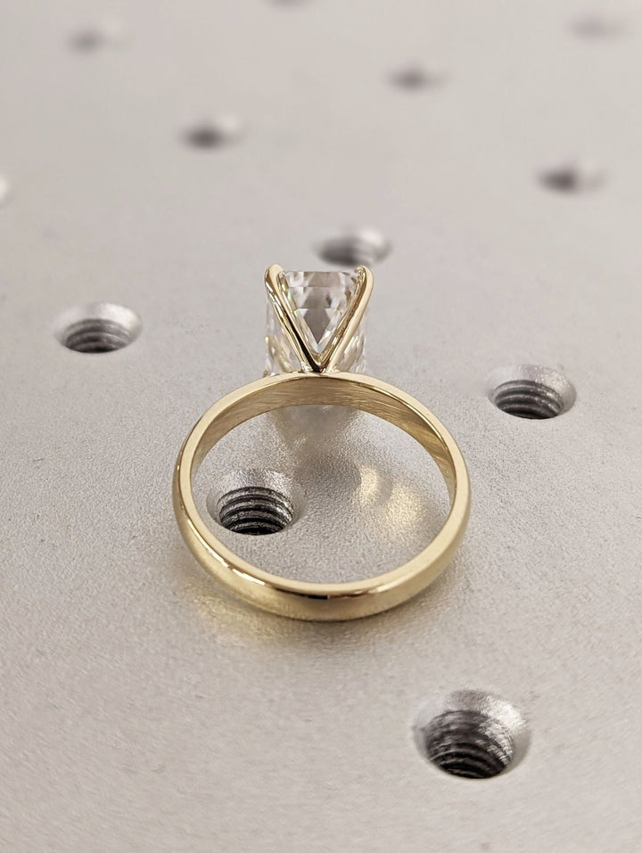 Macro shot of emerald cut diamond facets in solitaire ring setting