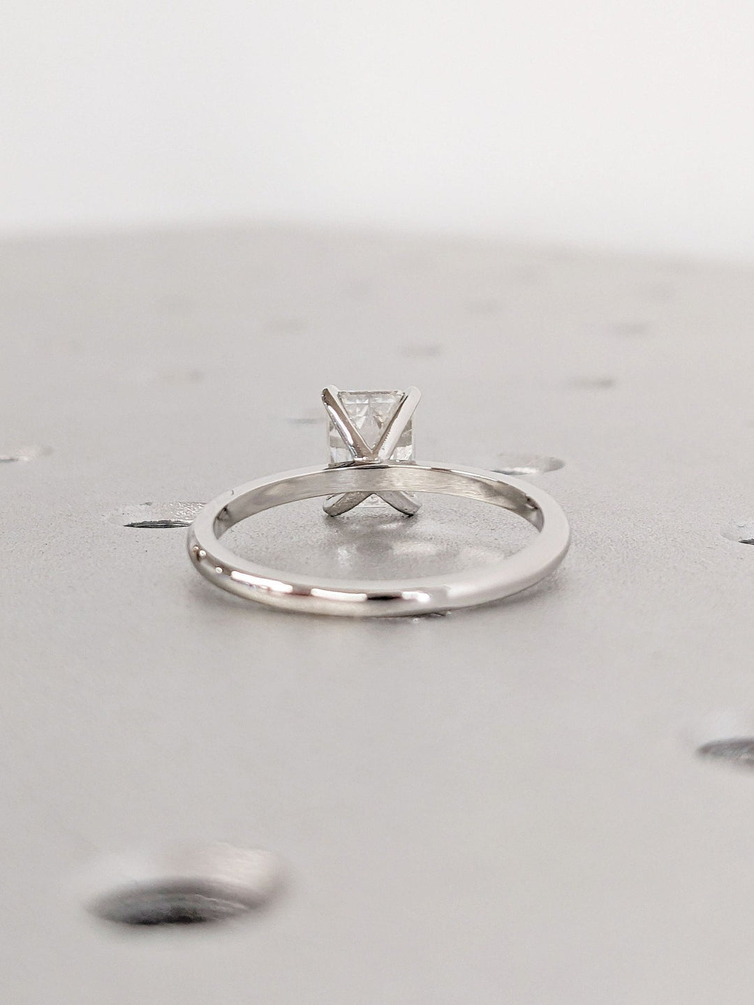 Emerald solitaire lab grown diamond ring side profile in gold setting