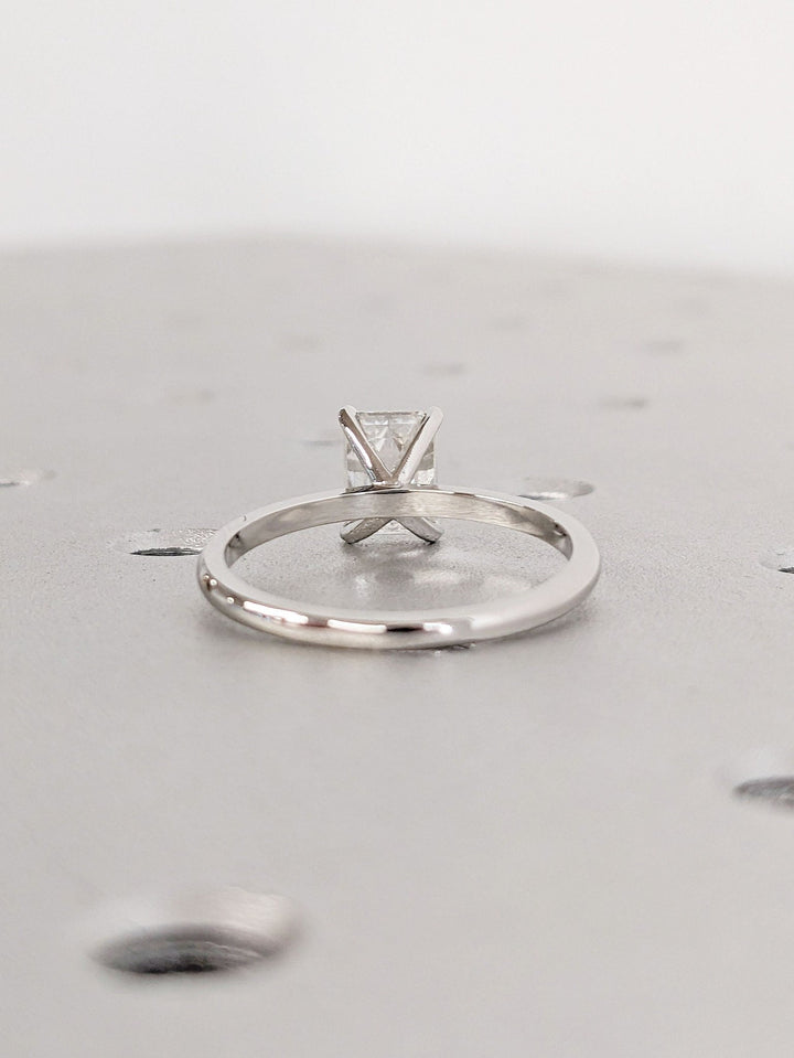 Emerald solitaire lab grown diamond ring side profile in gold setting