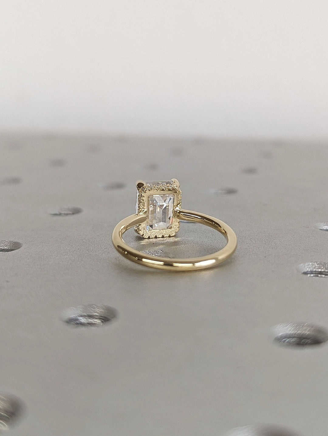 Emerald cut engagement ring side view showing band detail