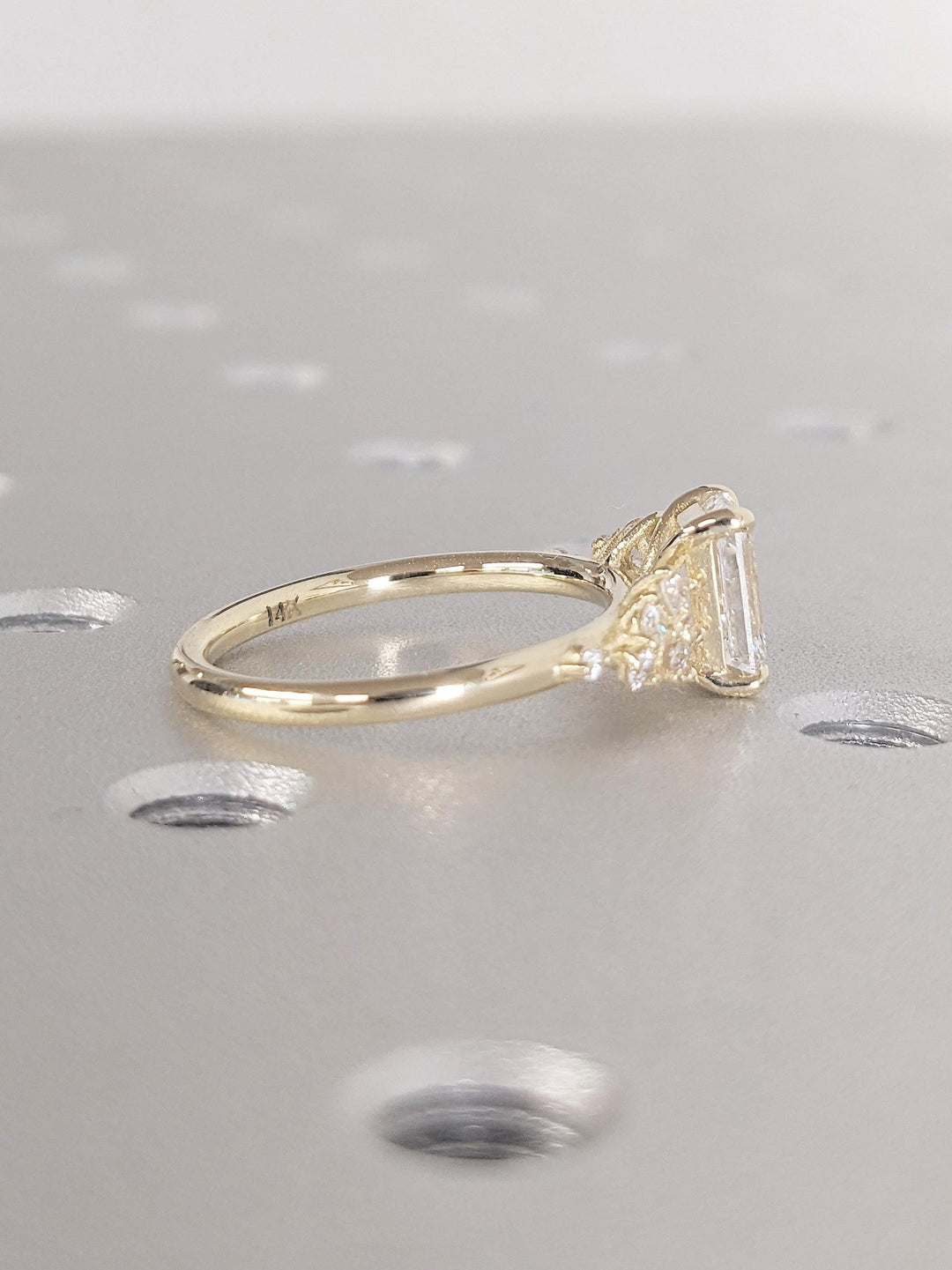 Emerald cluster engagement ring finished in polished solid gold