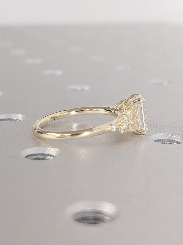 Emerald cluster engagement ring finished in polished solid gold