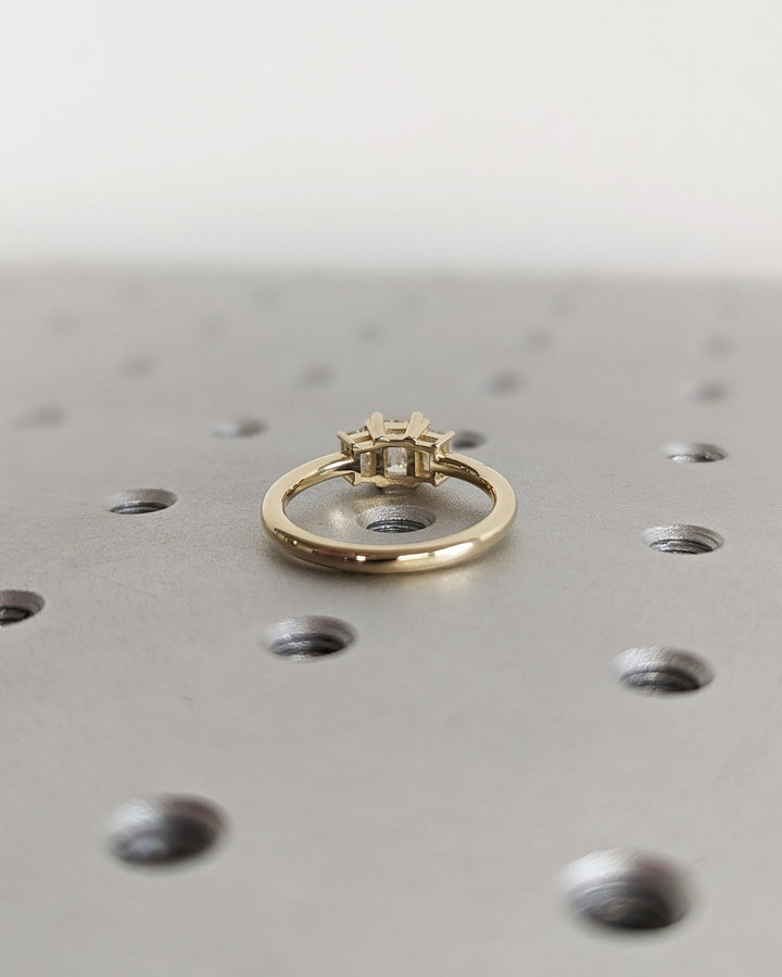 Emerald solitaire lab grown diamond ring side profile in gold setting