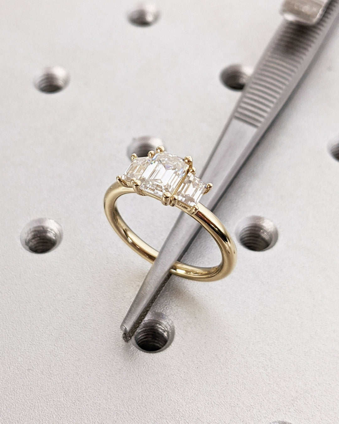 Close-up of emerald cut center diamond in solitaire engagement ring