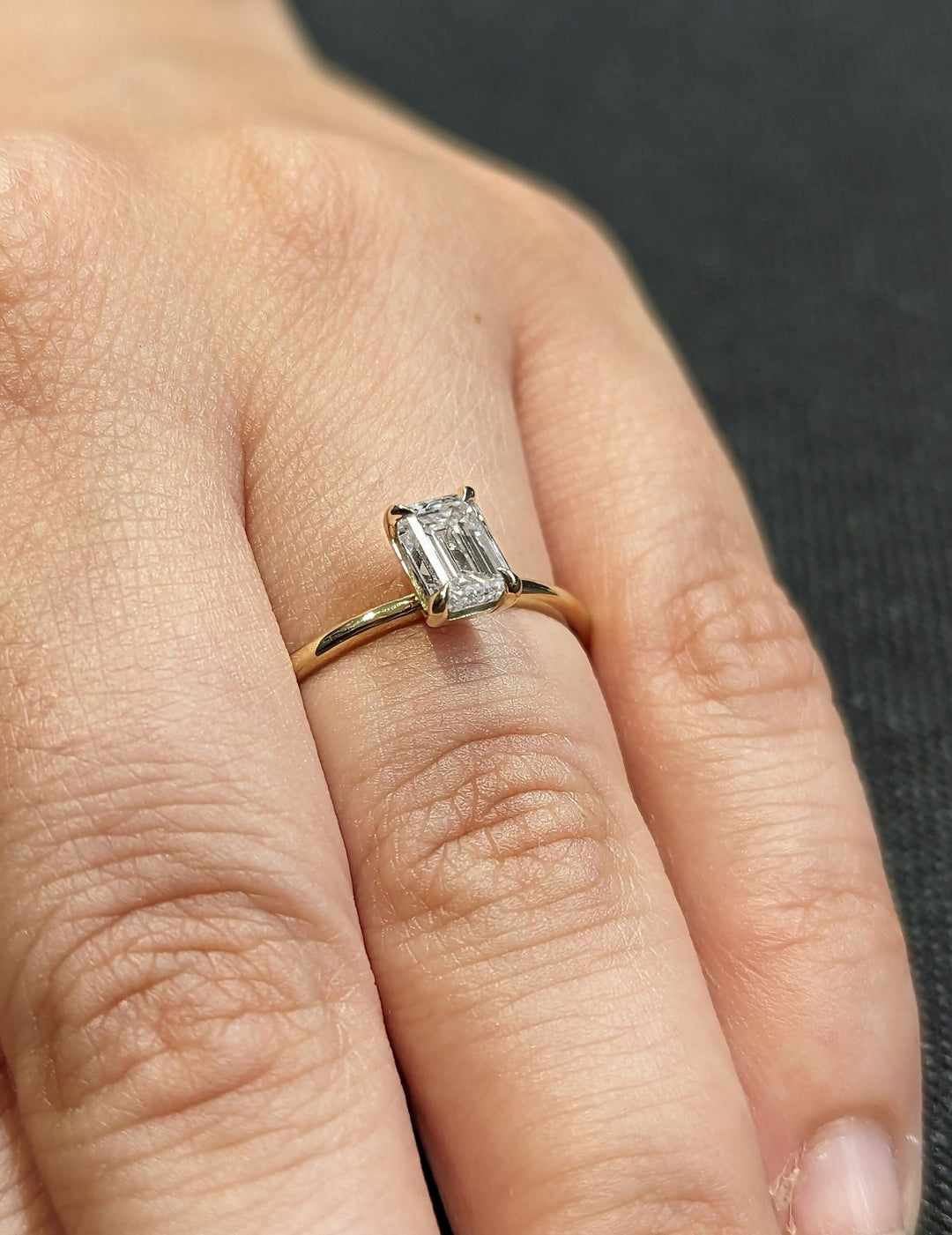 Emerald cut engagement ring side view showing band detail