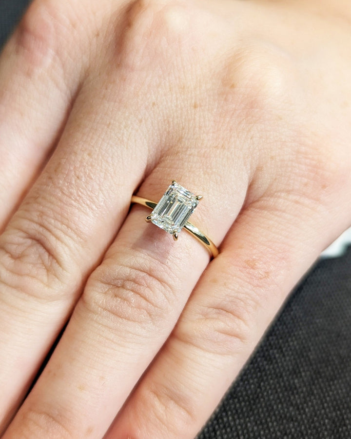 Emerald cut diamond ring worn on hand