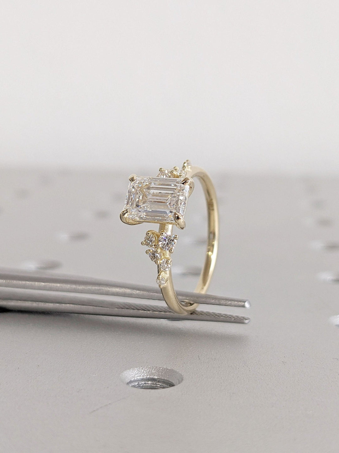 Emerald cut diamond ring worn on hand