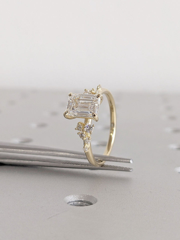Emerald cut diamond ring worn on hand