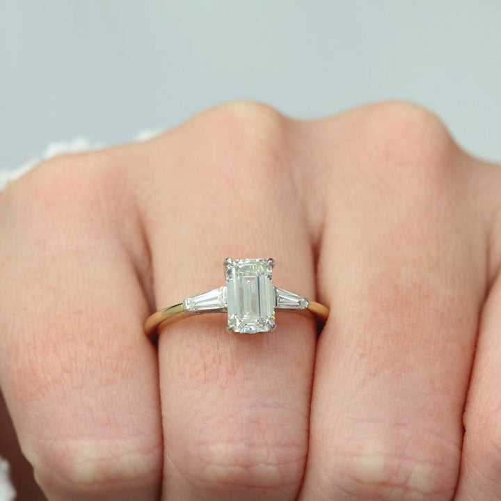 Emerald cut three stone engagement ring with IGI certified center diamond