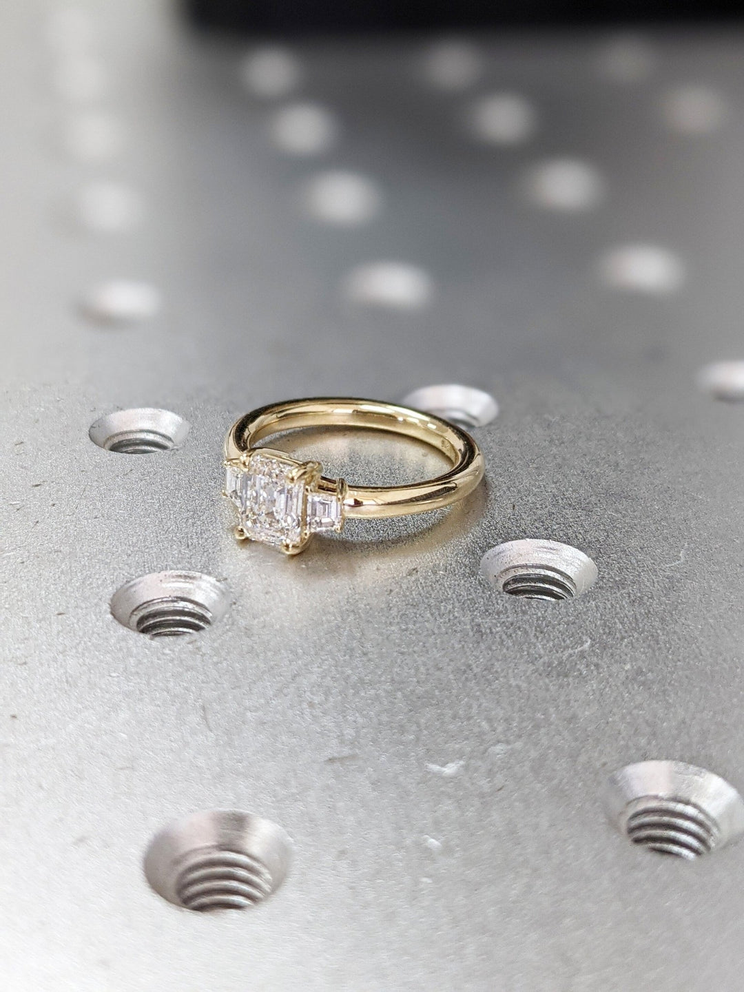 Emerald solitaire lab grown diamond ring side profile in gold setting