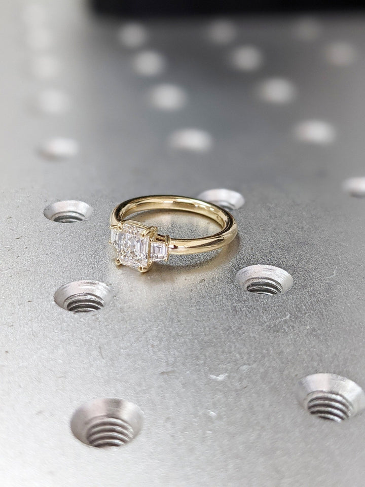 Emerald solitaire lab grown diamond ring side profile in gold setting