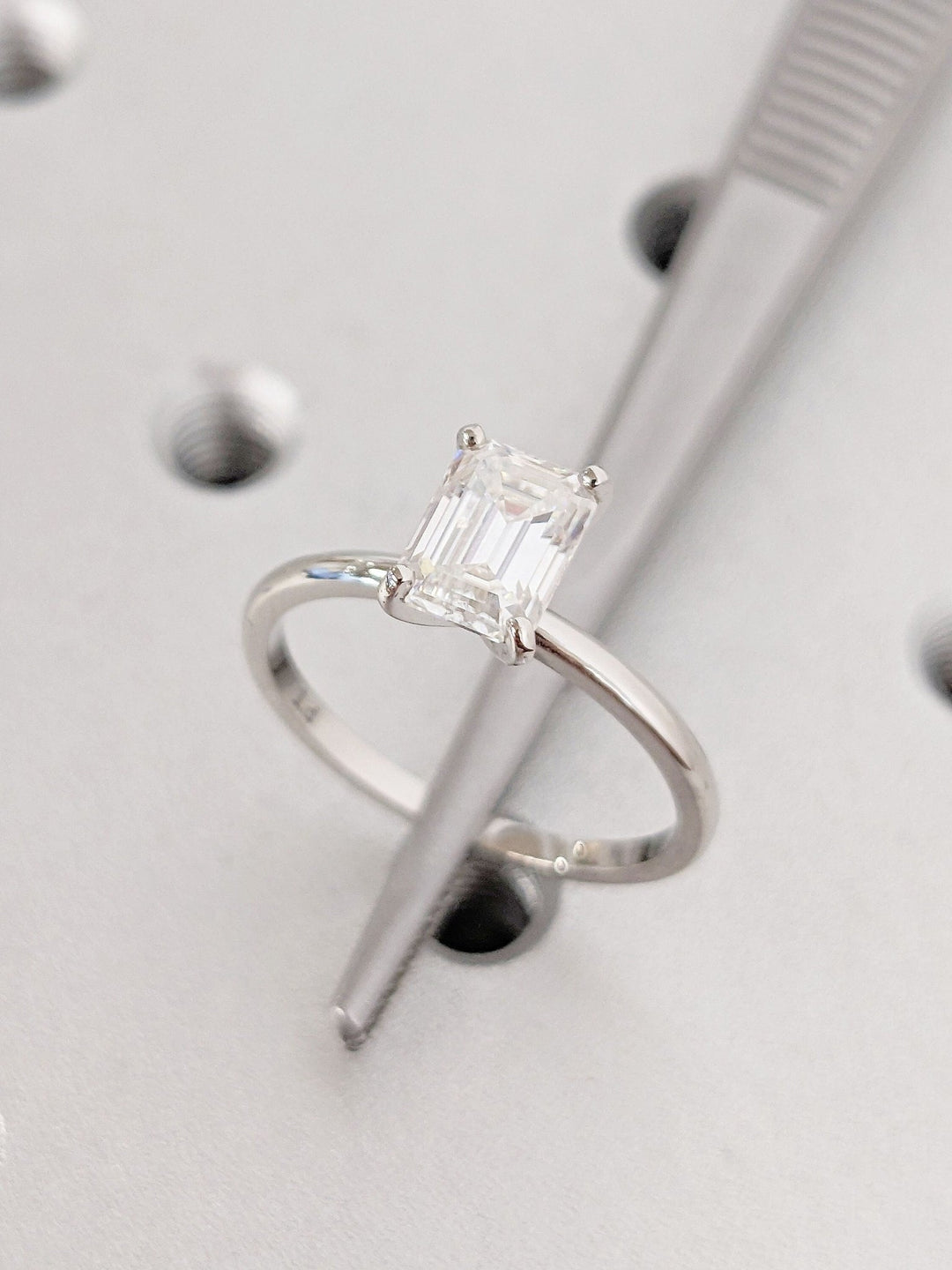 Emerald solitaire engagement ring viewed from the side
