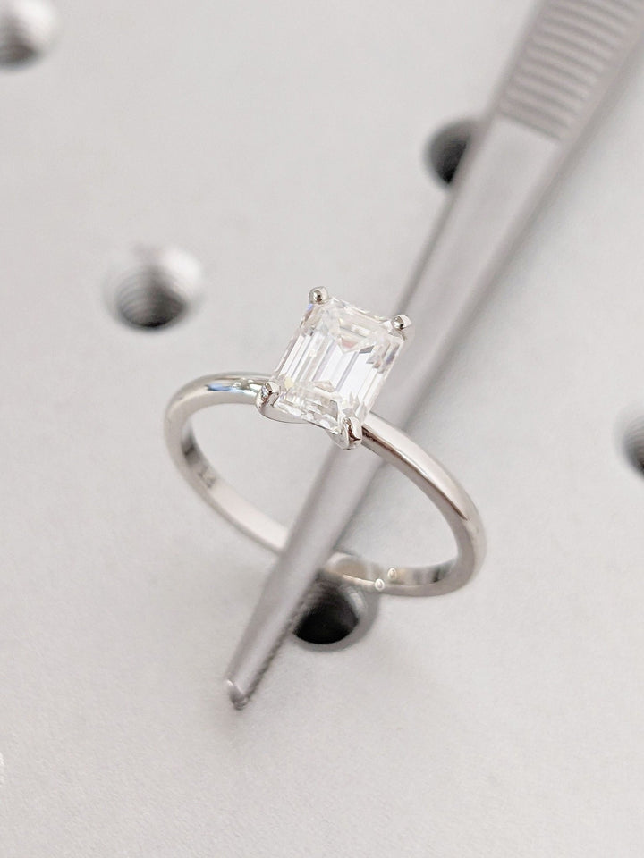 Emerald solitaire engagement ring viewed from the side