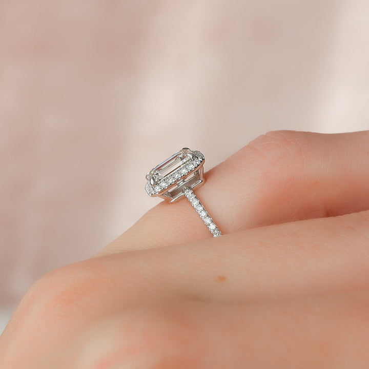 Detailed close-up of emerald pave diamond engagement ring