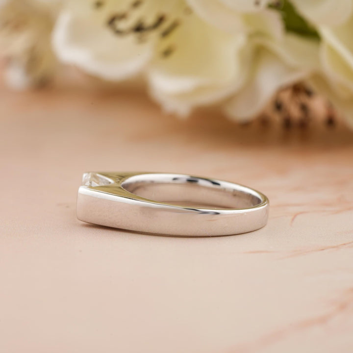 Fine craftsmanship detail on emerald east west engagement ring