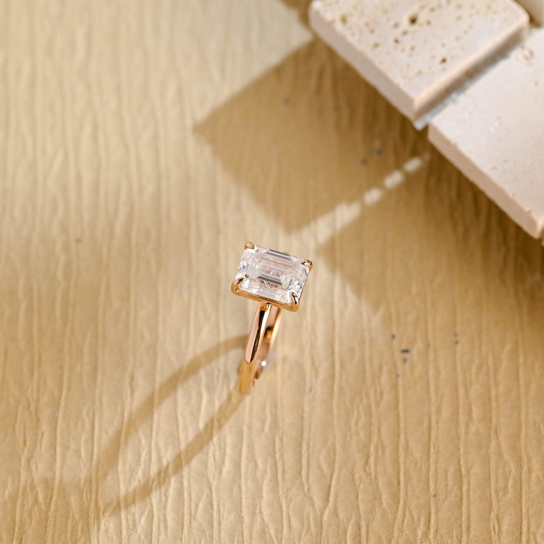 Emerald cut diamond ring worn on hand