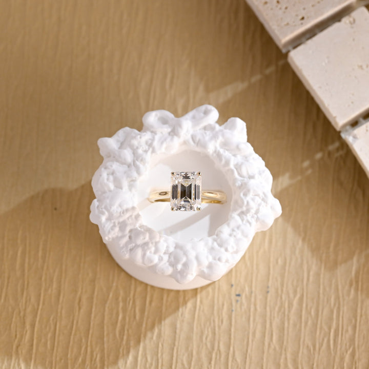 Side angle of emerald solitaire diamond engagement ring