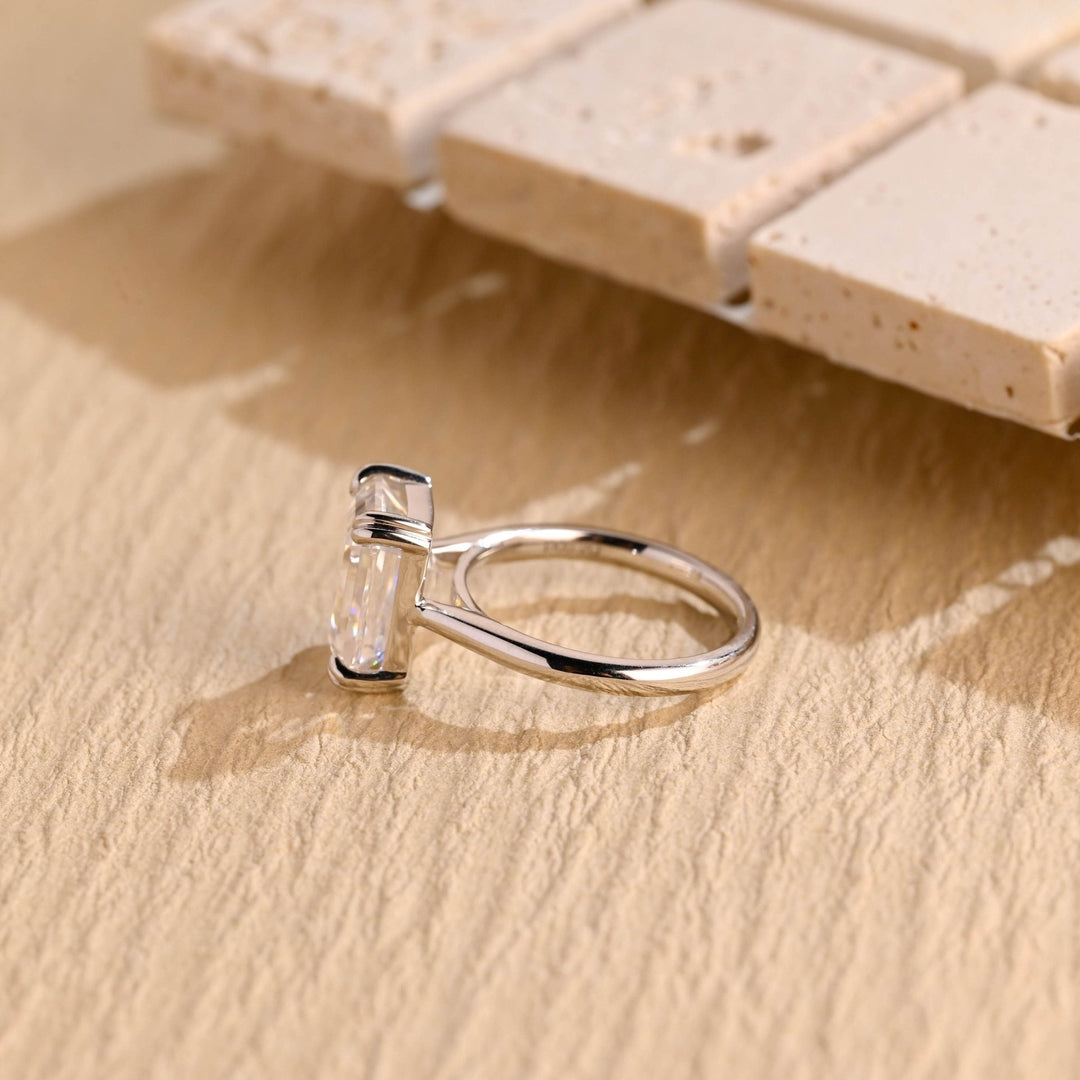 Fine craftsmanship detail on emerald solitaire engagement ring