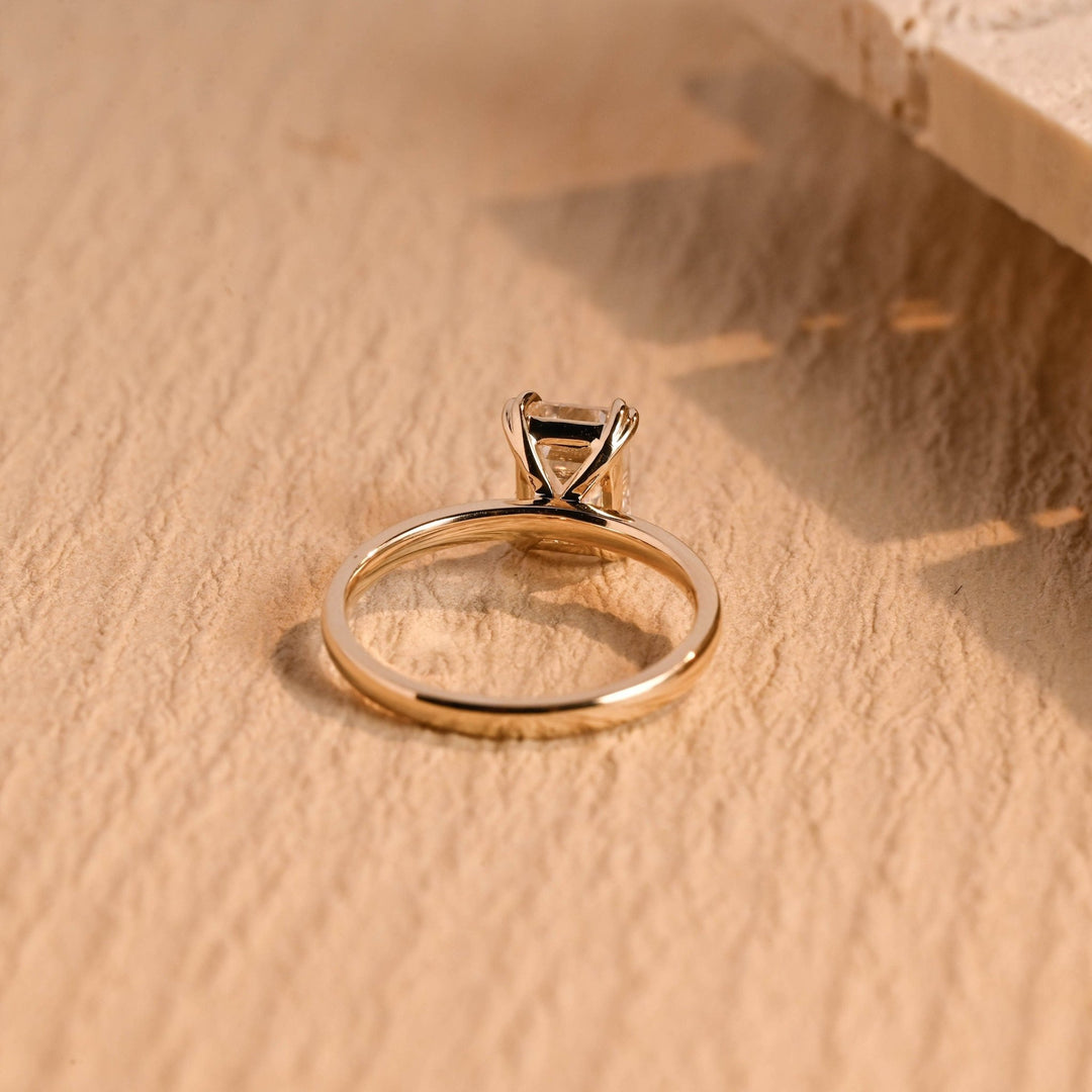 Emerald solitaire engagement ring close-up showing high clarity diamond clarity