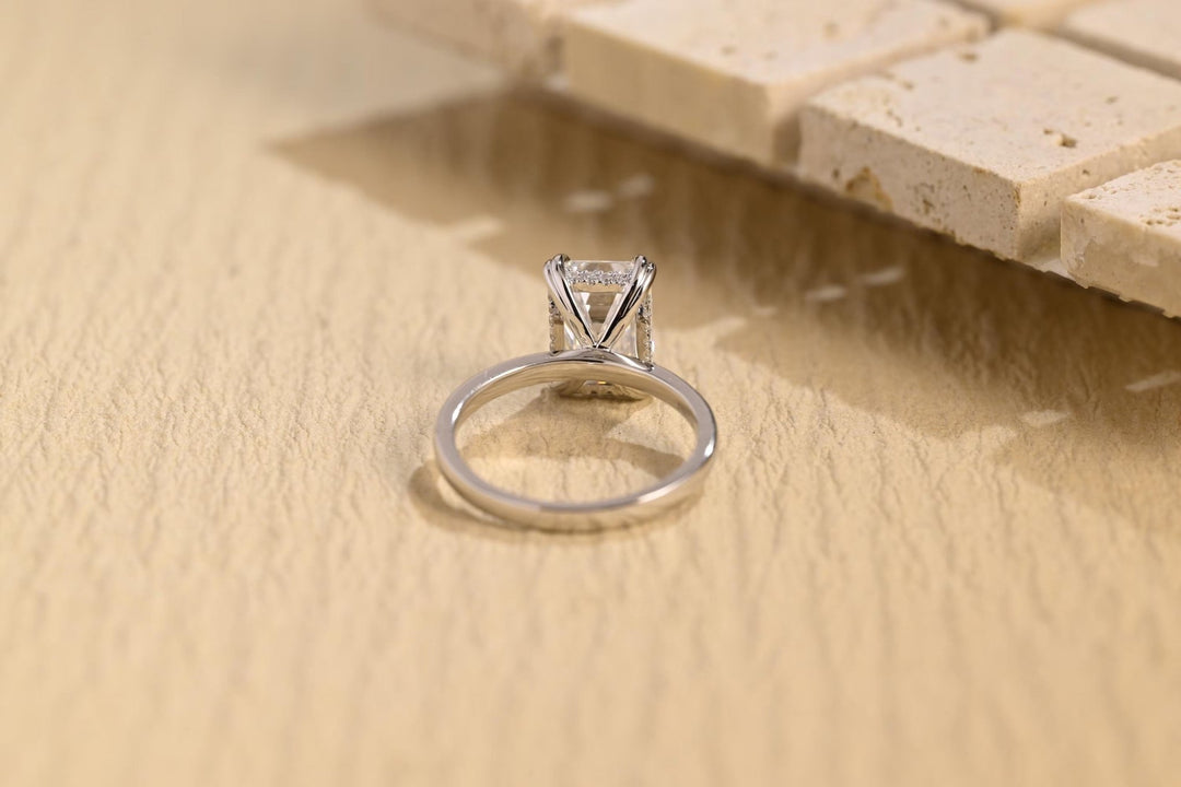 Emerald hidden halo engagement ring offered in gold and platinum