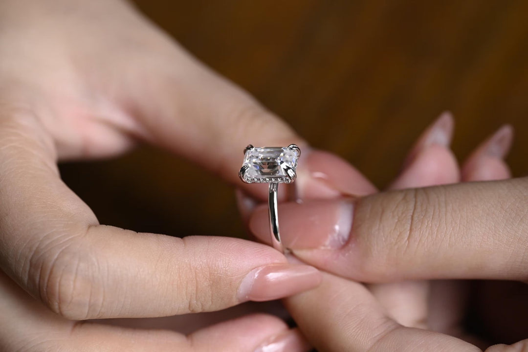 Emerald cut engagement ring shown with authenticity certificate