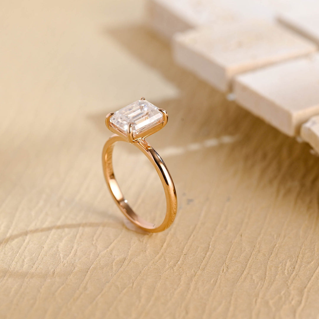 Emerald cut solitaire engagement ring shown in real-life wear