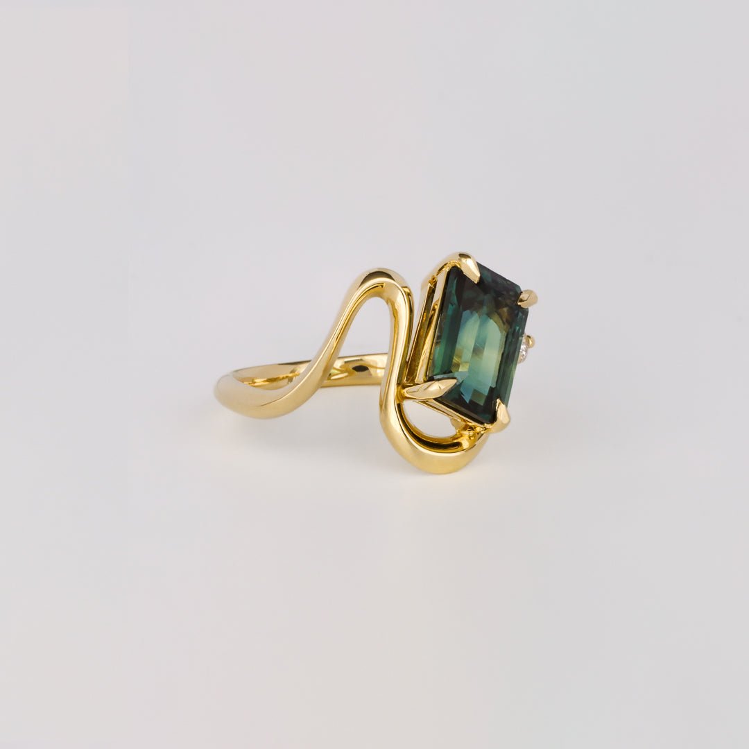 Emerald cut engagement ring shown with authenticity certificate