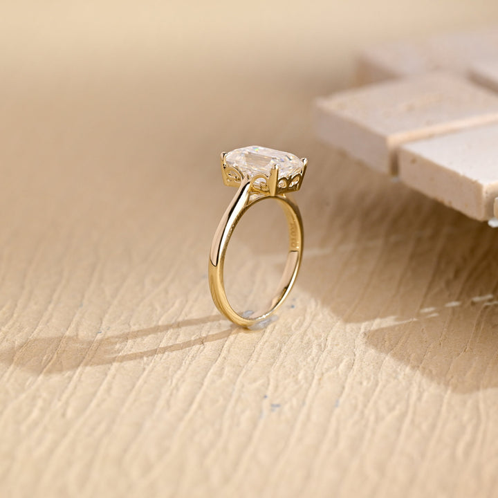 Emerald solitaire engagement ring shown on hand for true-to-life sizing