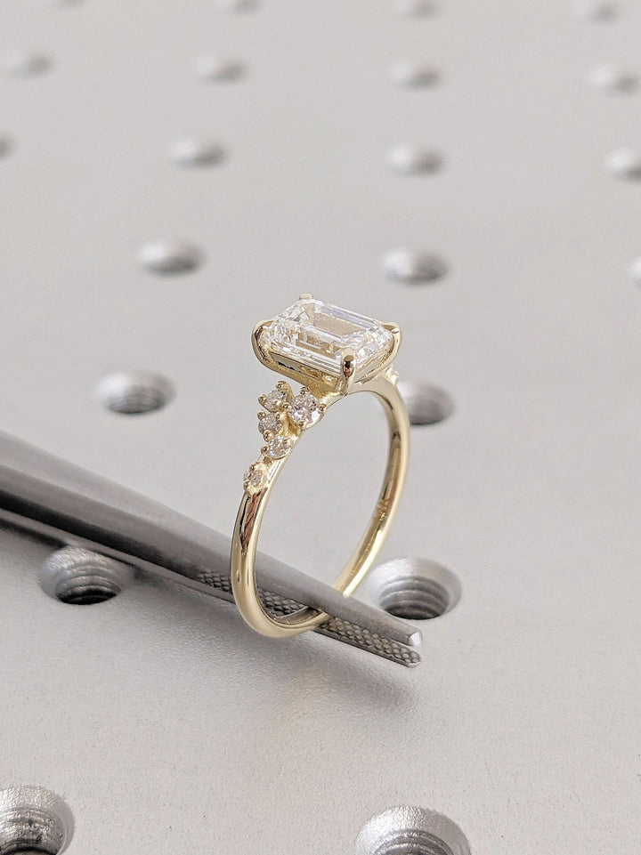 Emerald cut cluster engagement ring shown in real-life wear