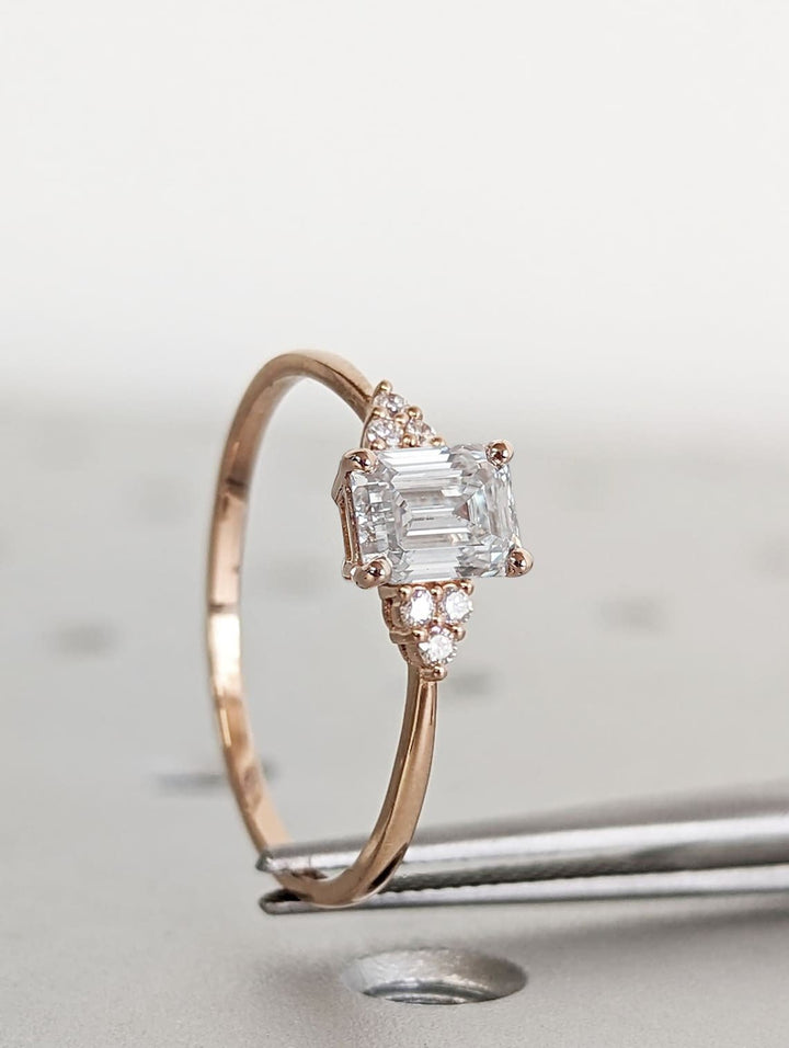 Emerald cluster engagement ring offered in gold and platinum
