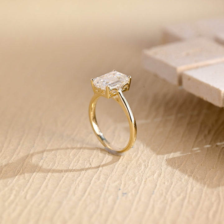 Emerald solitaire engagement ring viewed from the side
