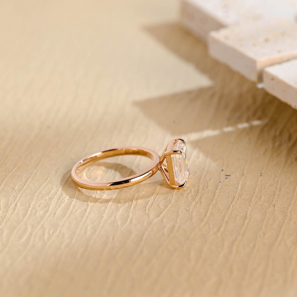 Emerald solitaire engagement ring shown on hand for true-to-life sizing